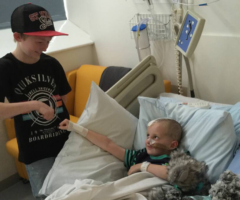 Campbell visits 5-year-old Duke Marcello in hospital in Smithton after he was critically injured when he was struck by a motorcycle.