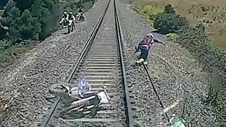 Biker narrowly escapes speeding train