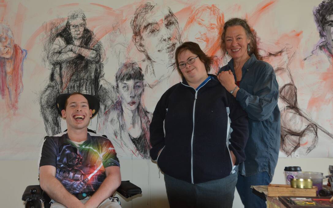 Interaction and art: Matthew Alley and Dushka Winkley with artist Jo Ernst, who has drawn their portraits. Photo: Lachlan Leeming.