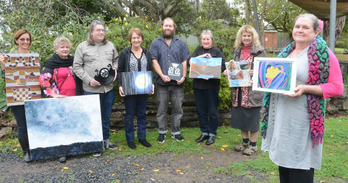 Brushes with Life: Kirsten Olsen from Flourish Australia, workshop facilitator Julienne Richardson, artist Peter Richards, mental health worker Christine Squires and artists Andrew Richards, Rosemary Darmody, Judy Hodgkinson and Kathleen Emslie with some of the artworks being exhibited this year.