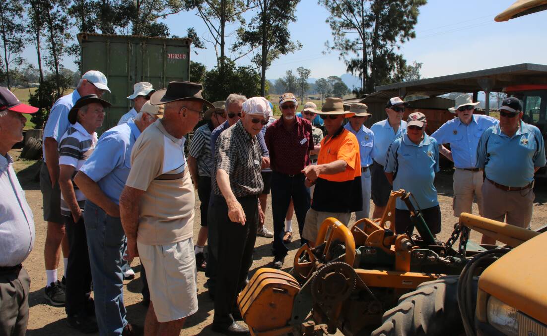 Education: Vernon Drury (in the high visibility shirt) explains to Taree Probus Club members the workings of the grass strip cutting machine.