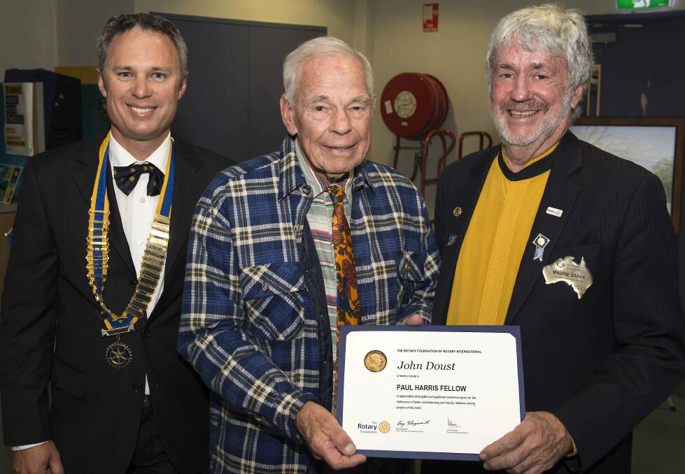 John Doust (centre) is congratulated by president Mark Drury and district governor Maurie Stack on being made a Paul Harris Fellow, one of Rotary's highest awards.