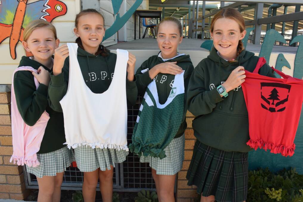 Old Bar Public School: Year 5/6 students Ruby Dunn, Amber Northam, Pia Anker and Jemma Holley with just some the re-purposed bags made from unwanted t-shirts and singlets.