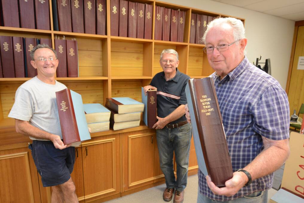 Museum bound: Warren Whitley, Bruce Gibson and Bert Love from the Cundletown and Lower Manning Historical Society remove the bound copies of the newspaper from the shelves at the Manning River Times office.