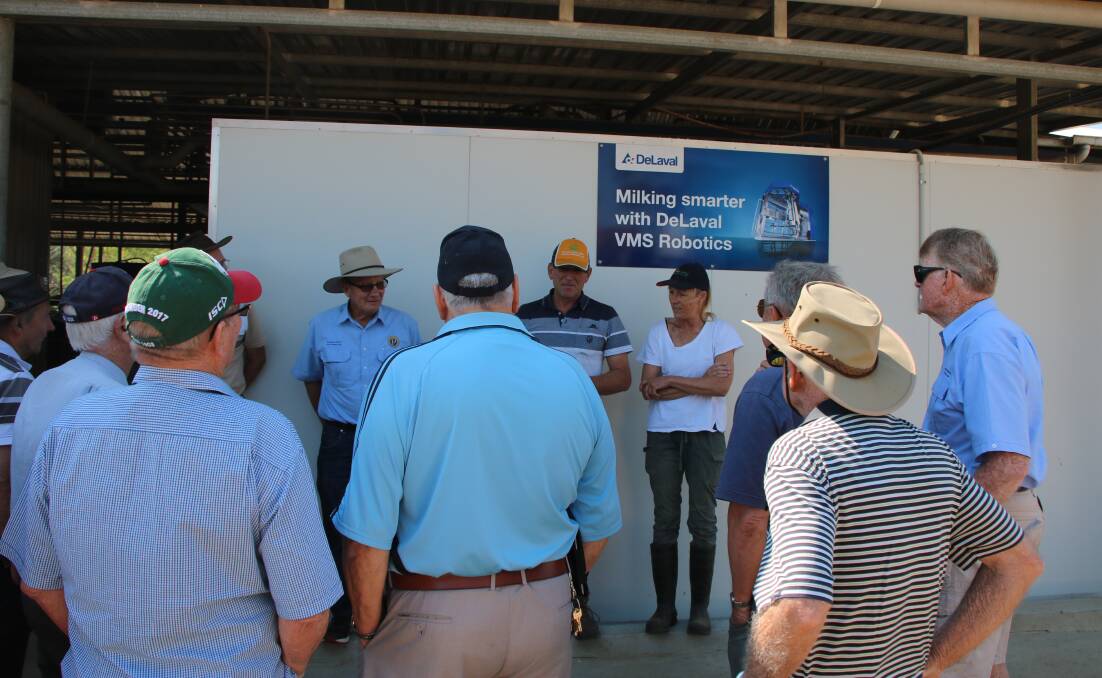 Adrian and Stella Drury (under sign) greet members of Taree Probus Club to their robotic dairy, prior to a tour of the facility.