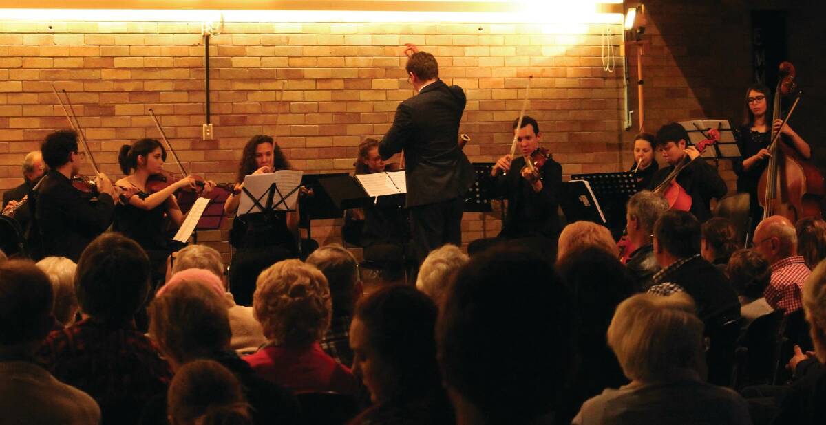 Jonathan Billingham conducts musicians at a previous performance.