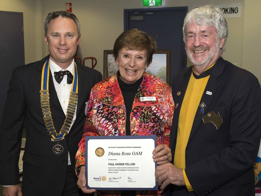 Diana Rose (centre) is congratulated by Rotary Club of Taree outgoing president Mark Drury and district governor Maurie Stack on being made a Paul Harris Fellow, one of Rotary's highest awards.