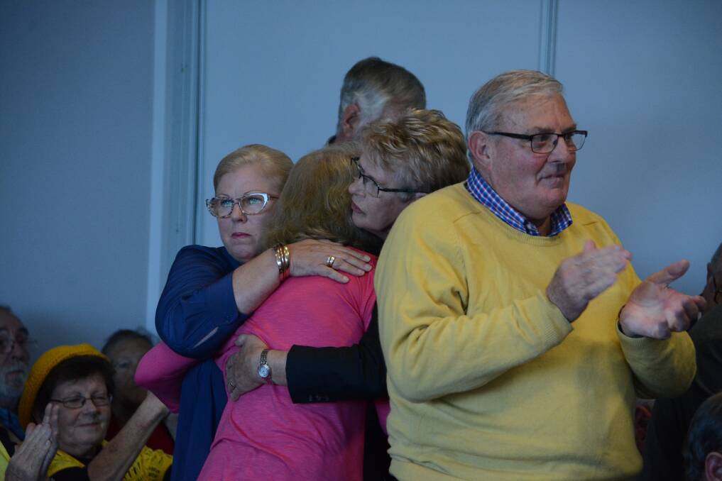 Support: Mary Ann Tickle and Pattie Hogan hug Cathy Posselt, the wife of former Greater Taree general manager Ron Posselt, following her emotional address. 