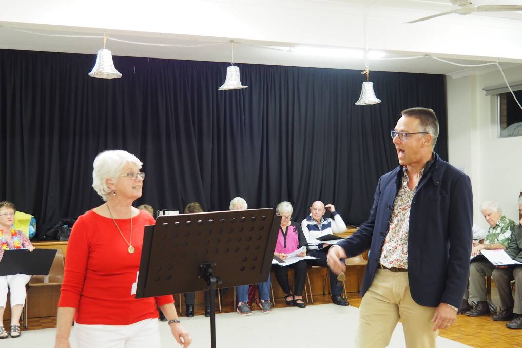 On song: Robyn Rankin and Phil Rayson sing “Baby It’s Cold Outside”. In the background are Gina Douglas, Carol Dever, Leo Yarnold and Will Knight.