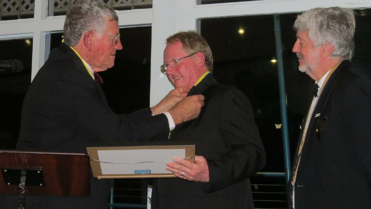 President of Rotary Club of Taree on Manning Paul Tollis presents Terence Kitching with his Paul Harris Fellow.