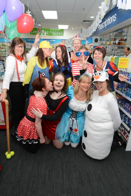 Crazy characters: Taree stores participating in Crazy Day are encouraged to dress up to add to the fun atmosphere of the sale day. Pictured are some familiar characters at Chemmart Pharmacy in 2015.