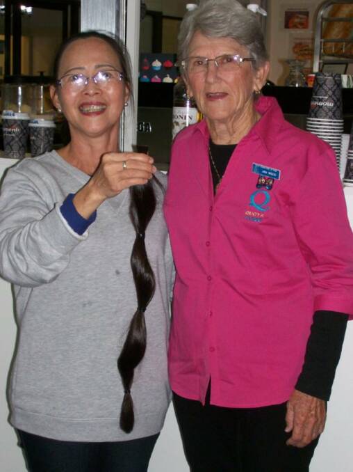 Kim Nguyen with Quotarian Jan Wood. Kim holds her long locks, which are on the way to the Alopecia Foundation.