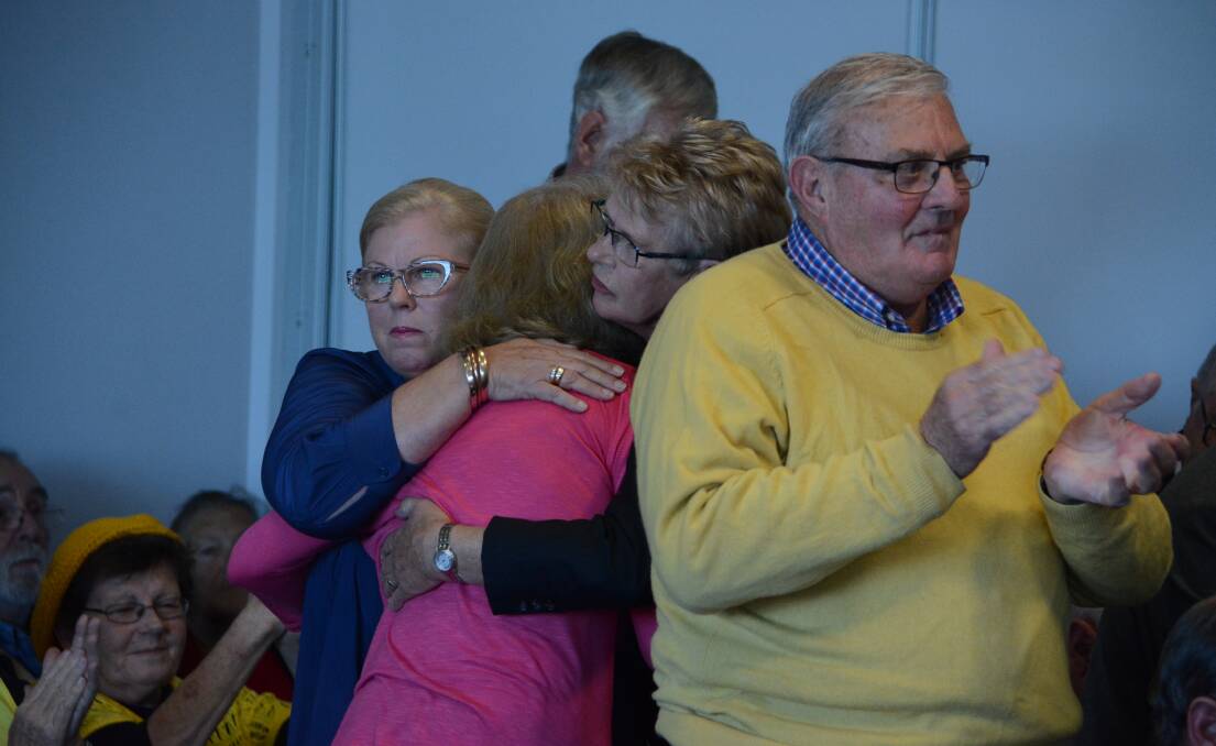 Support: Mary Ann Tickle and Pattie Hogan hug Cathy Posselt, the wife of former Greater Taree general manager Ron Posselt, following her emotional address. Carl Muxlow photo.
