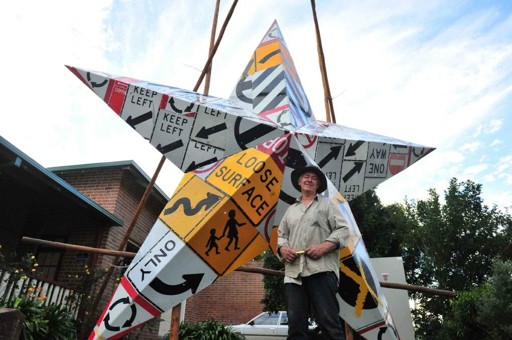 Artist Rick Reynolds with his sculpture made from road signs which has been in a prominent location in front of Manning Regional Art Gallery, located in Macquarie Street, Taree. Photo: Julie Slavin.