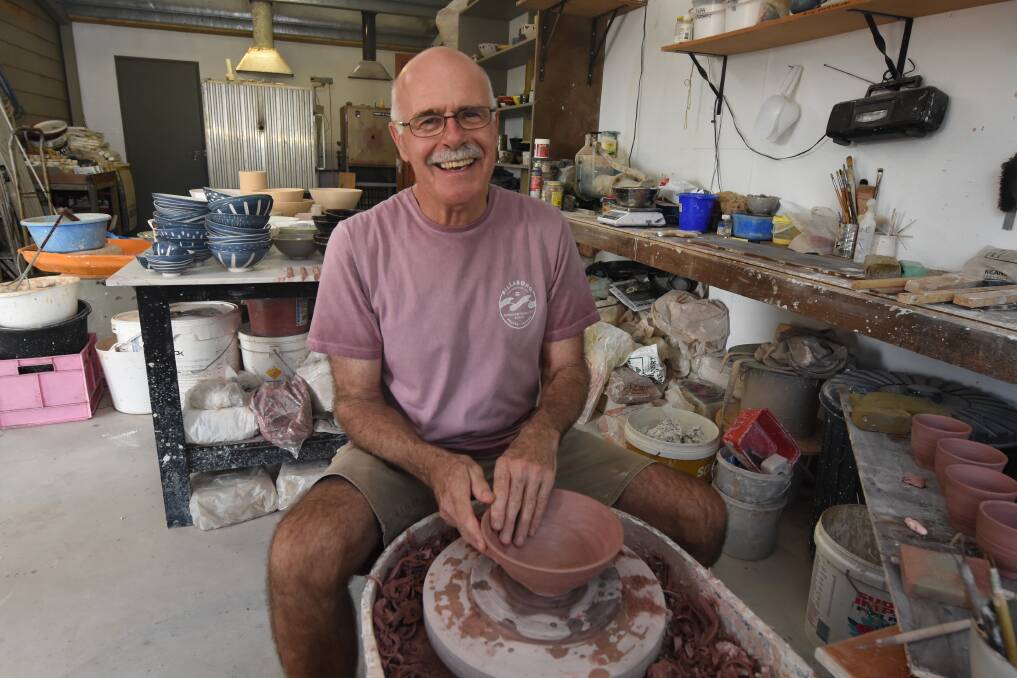 Where it all happens: Peter Hugill works on a bowl on the turning wheel in his studio. Photo: Scott Calvin.
