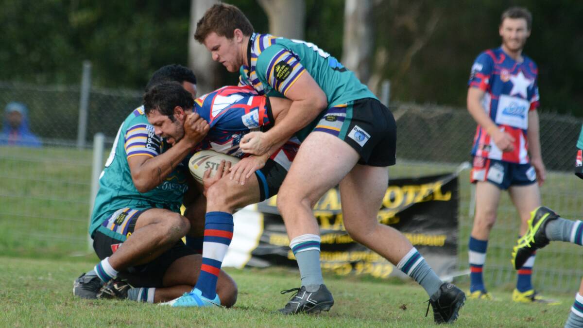 Taree City defenders wrap up Old Bar centre Alan McDonald during the clash at the Jack Neal Oval. The game ended in a 25-25 draw.
