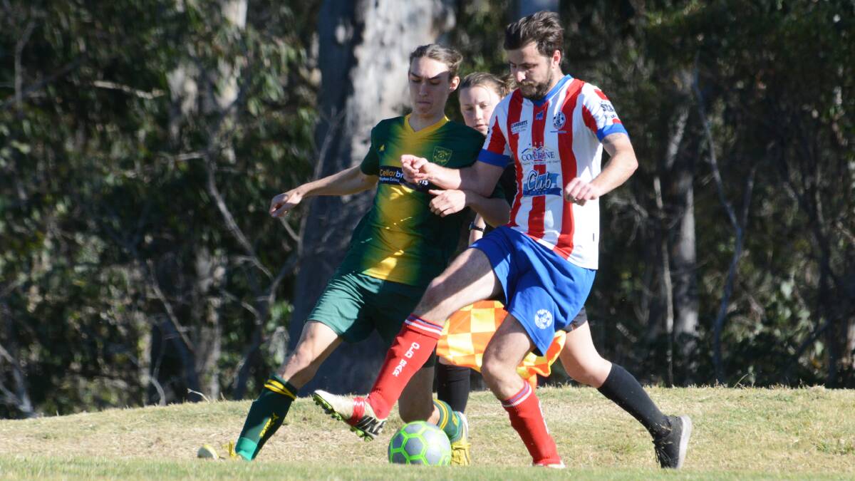 Kurt Shirmer and James Gregory battle for possession during the preliminary final at Wingham between Wingham and Old Bar. Wingham won 1-0.