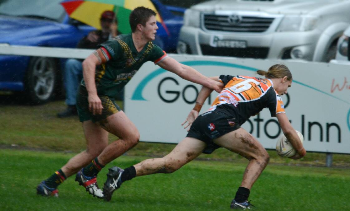 Wingham five-eighth Tahj Wood beats a tackle to score against Forster-Tuncurry last Sunday at Wingham. He is in doubt for Saturday's clash against Port Macquarie at Port Macquarie.
