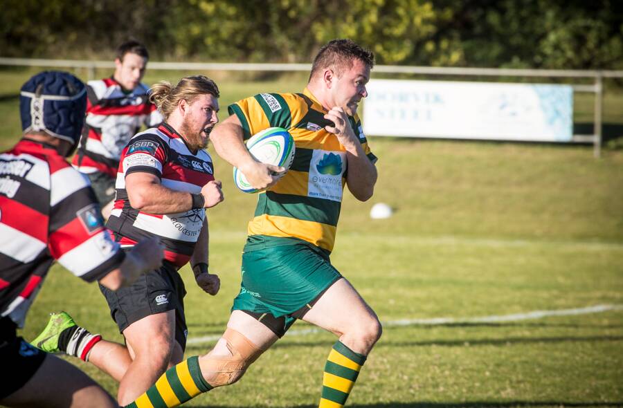 The Dolphins’ rugby union lock Pat Randall in full flight with Gloucester’s five-eighth Ken Wamsley in pursuit at Tuncurry on Saturday. Photo Zac Lyon.