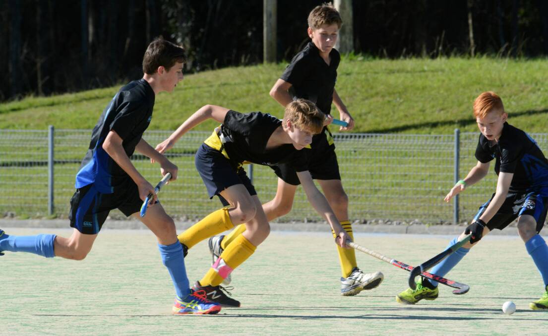Port Macquarie's Hamish McKie in the thick of the action during the NSW under 15 boy's hockey championship played at Taree.