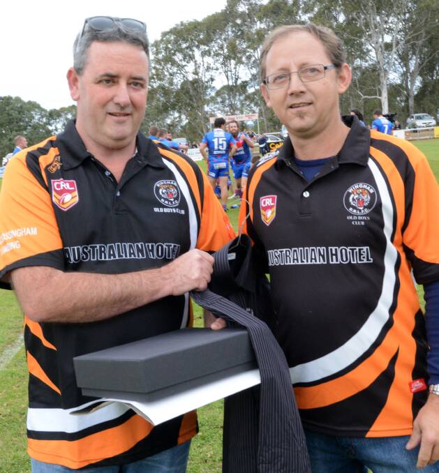 Wingham Rugby League Club's newest life member, Wayne Goward, is congratulated by Wingham Old Boys president Stephen Blanch.