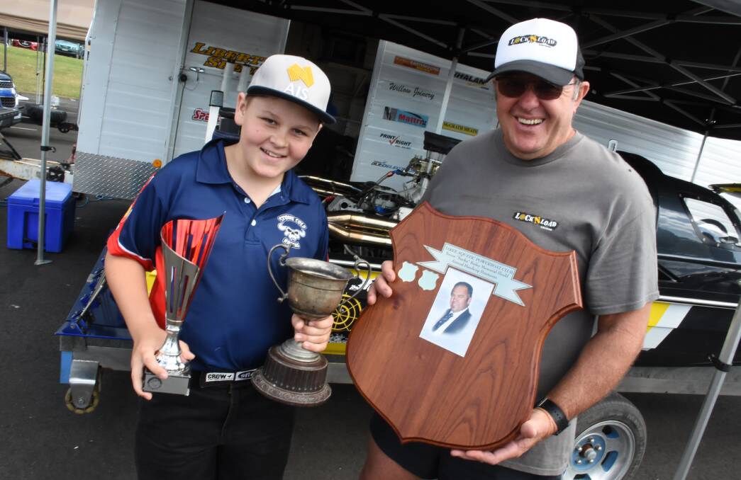 Steve Hutchen presents Kyle Carle with the Trevor Bailey Memorial Shield. Kyle is also holding the trophy won by his grandfather, powerboat pioneer Alan 'Bindy' Carle in 1952.