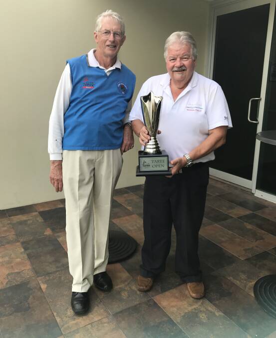 Taree Golf Club captain Peter Wildblood presents Greg Turner with the trophy after his win in the Taree Open.