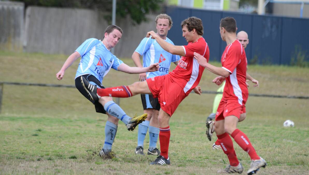Old Bar's Toby Gollan in a kick-fest with Taree opponents during a premier league clash at Omaru Park in 2014.