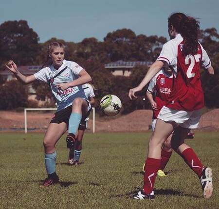 Abbi Watson goes for goal for Football Mid North Coast under 18s during a match this season.