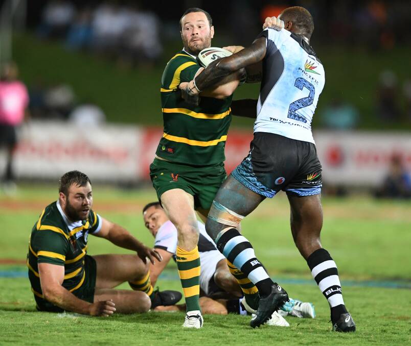 Australian vice captain Boyd Cordner attempts to shrug off a tackle in the trial game against Fiji in Suva.
