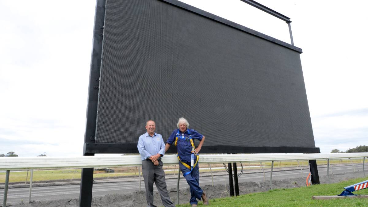 Greg Hile from Taree-Wingham Race Club and Steve Smith from installers Oxley Optia check out the new screen to be a feature at the Bushland Drive track.