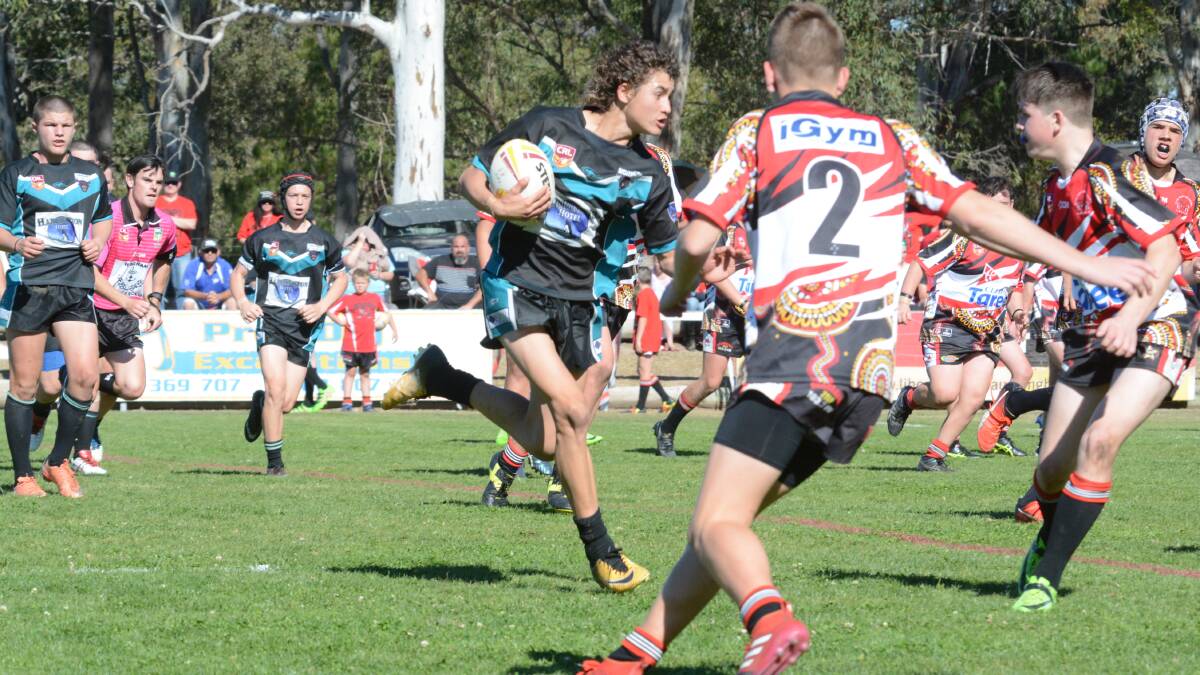 Taree's Jarrad Gibson makes a run during the Group Three Junior Rugby League under 15 grand final against Red Rovers. Gibson was named player of the match in Taree's 36-8 win.