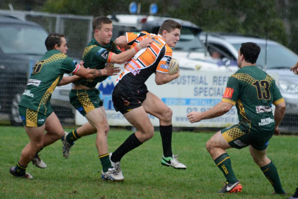 Wingham fullback Callum Wesley is taken by Forster-Tuncurry defenders during the Group Three clash at Wingham.
