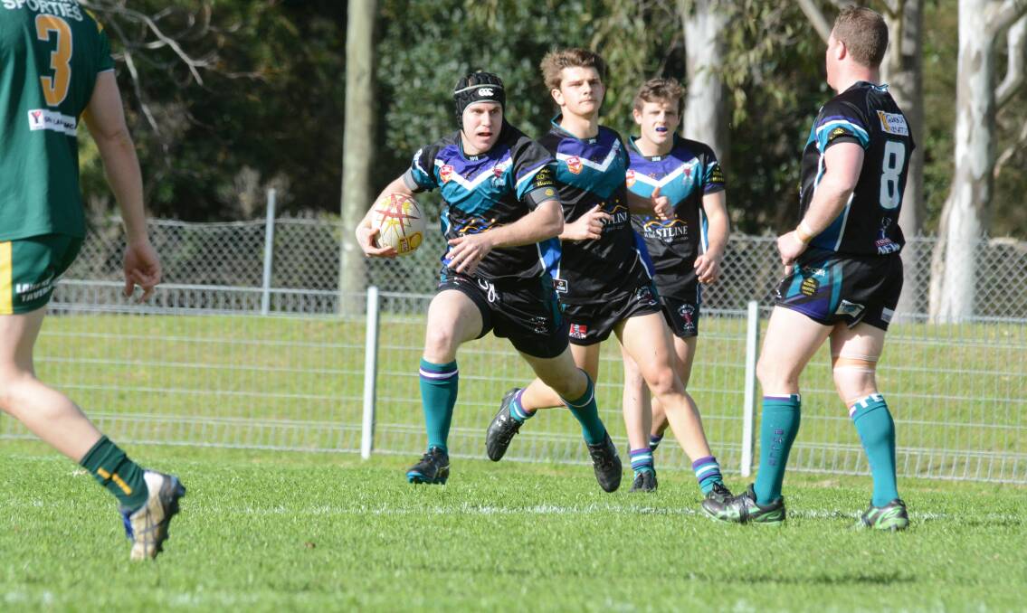 Taree City winger Steve Barnard takes the ball to the Forster-Tuncurry defence during the elimination semi-final played at the Jack Neal Oval.