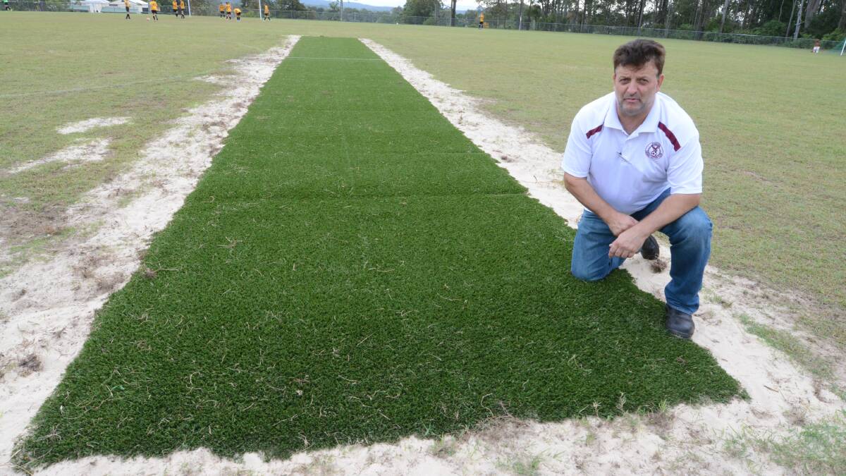 Tinonee Soccer Club president Laurdent Gonfond at the synthetic wicket at the Tinonee Recreation Reserve. Tinonee soccer and football clubs hope to get funding to install a turf wicket at the ground.