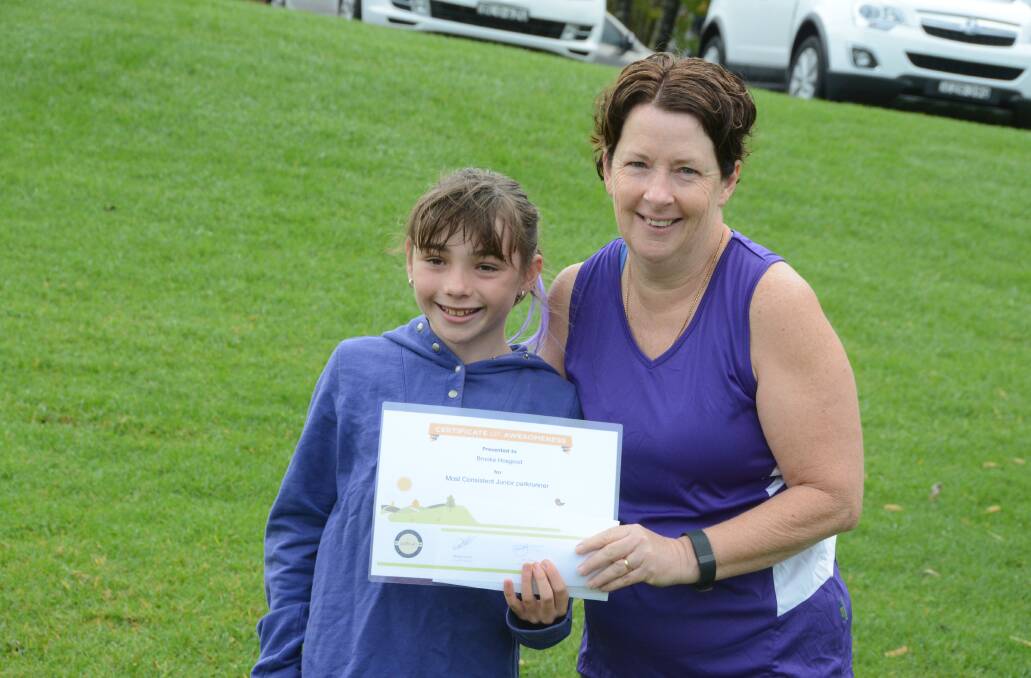 Brooke Hosgood receives here award for Taree parkrun's most consistent junior from Kerrie Norris.