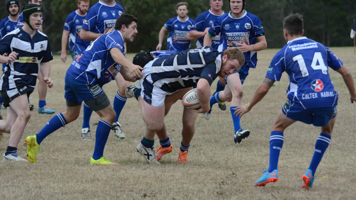 Manning Ratz utility player Brody Howard is nabbed by Wallamba defenders during the Lower North Coast rugby union fixture at Taree.