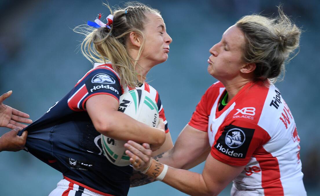 Holli Wheeler (left) tackles Brydie Parker of the Roosters in the NRL Women's Premiership match at Allianz Stadium in Sydney.. (AAP Image/Dan Himbrechts