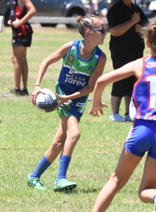 Taree under 12s player Lillianah Williams prepares to unload during a clash in the recent Northern Eagles Junior Championships at Taree. Ten Taree sides will play at the State Junior Cup in Port Macquarie this weekend.