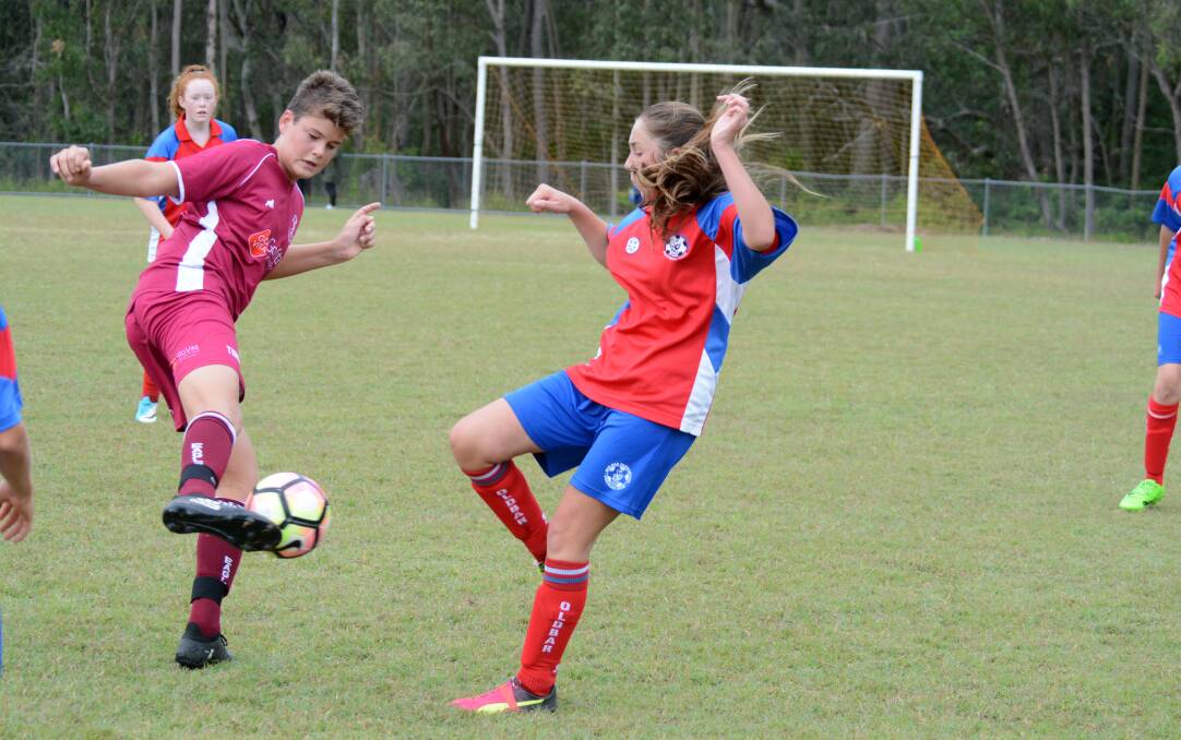 Matthew Stepowikow and Kriya Sercombe battle for possession during the Old Bar and Tinonee under 15s clash at Tinonee.