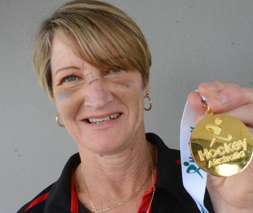 Katrina Hayes with stitches, black eyes a broken nose and a gold medal. Photo Scott Calvin.