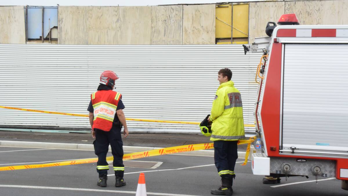 Taree Fire Brigade members block the footpath in front of the building amid fears the facade would collapse. Photo Anne Keen.