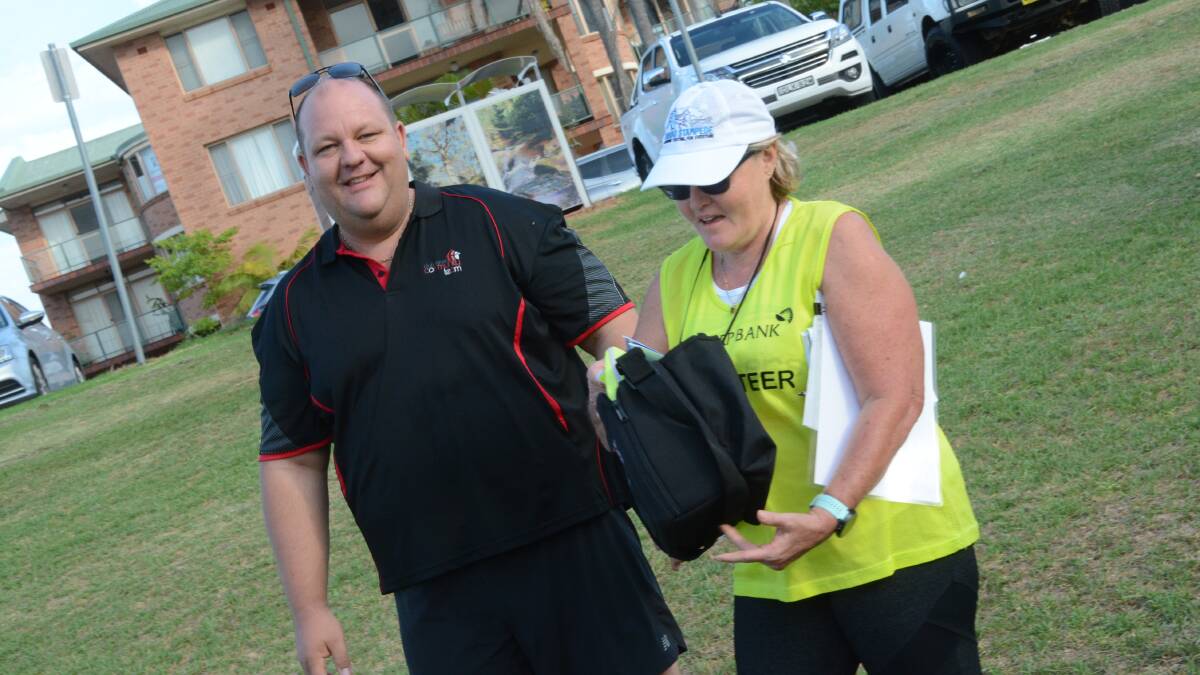Club Taree's brand and communications manager Paul Allan, hands over the defibrillator to Taree parkrun run director Marg Lewis.