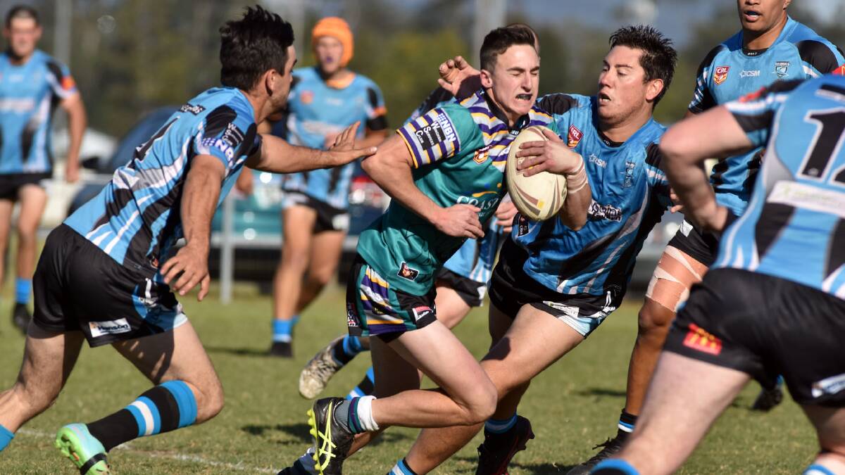Taree City fullback Dean Mills is taken by Port Macquarie defenders during the Group Three Rugby League minor semi-final played at Wauchope. The Bulls won a cliffhanger 32-28. Photo Ivan Sajko/Port Macquarie News