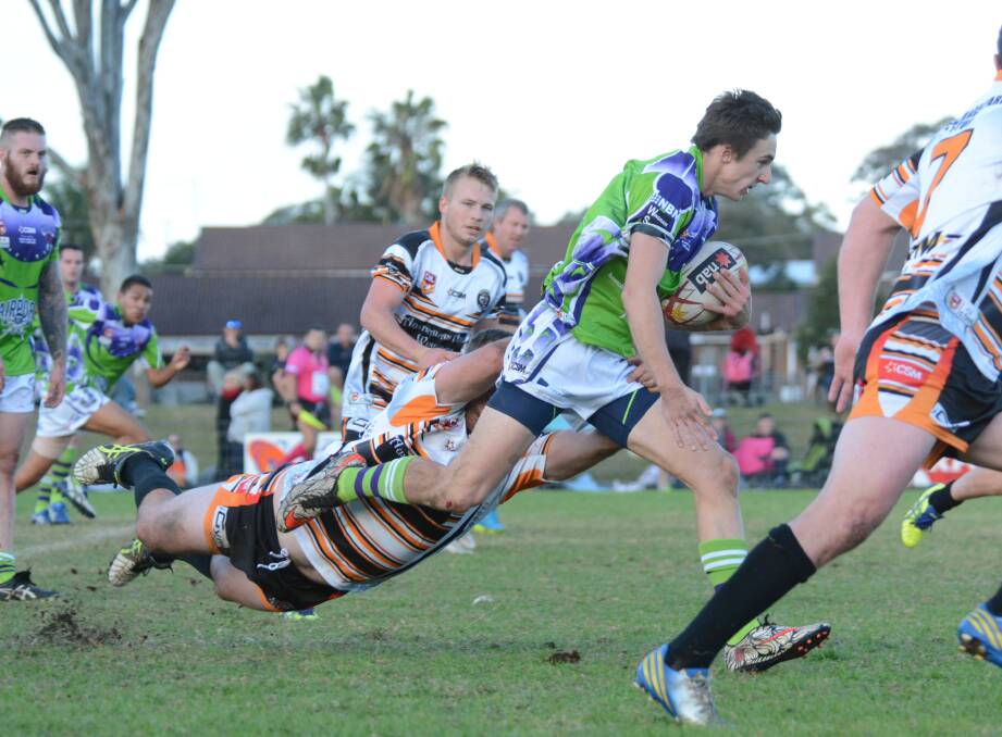 Promising Taree City centre Shannon Mullay tries to beat a Wingham tackle during the clash at the Jack Neal Oval. The Bulls meet Port Macquarie on Sunday at Taree.