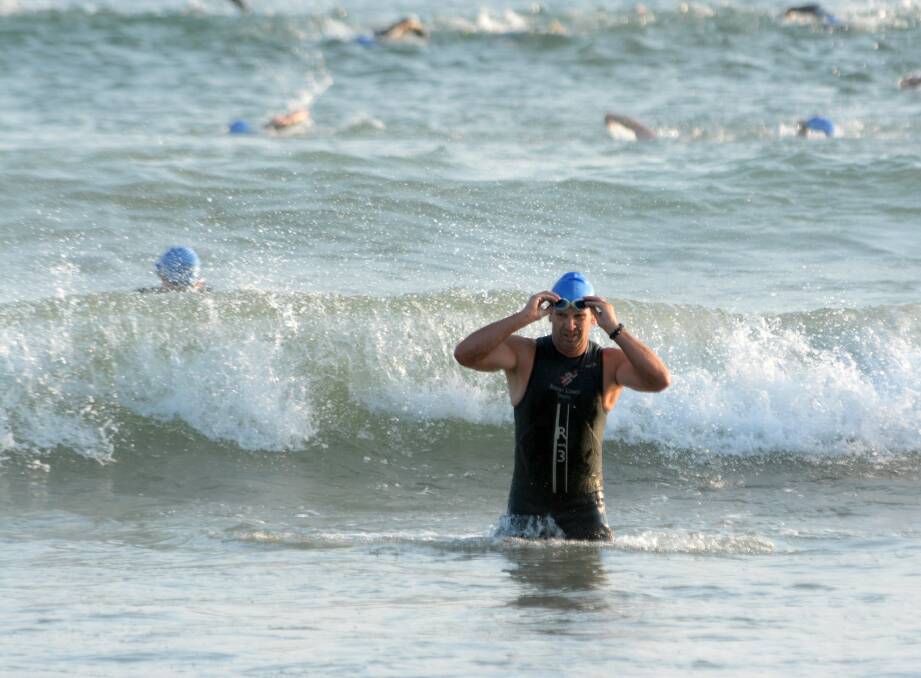 Triathletes make their way out of the surf at the start of last year's Acclaimed Financial Services Crowdy Bay Triathlon.