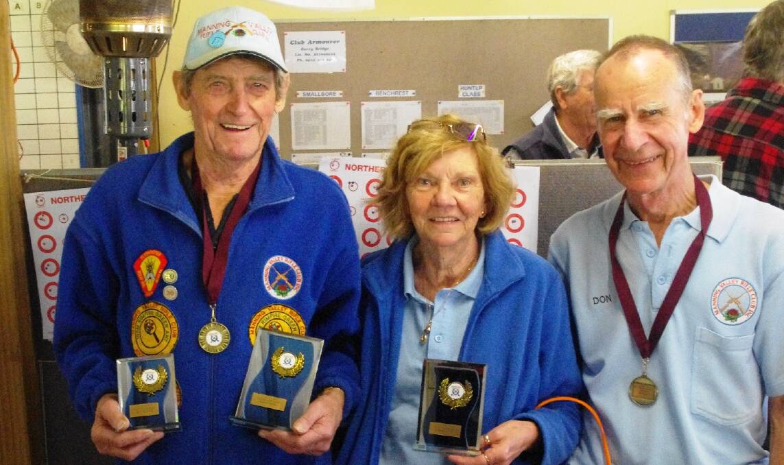 Winners are grinners: Manning Rifle Club members Ron Nutt, Robyn Wilson and Don Powell with their trophies from the regional shoot at Port Macquarie.
 