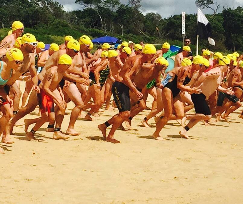The field races to the surf at the start of last year's Head2Head ocean swim. A field of more than 100 is expected to take part in Sunday's program.