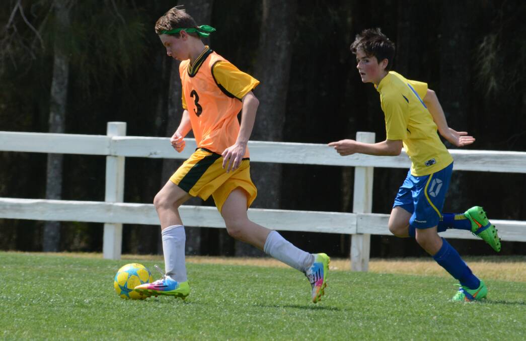 Cundletown's Brayden Brooks makes a charge during the southern under 13 grand final against Pacific Palms, won by Palms.
