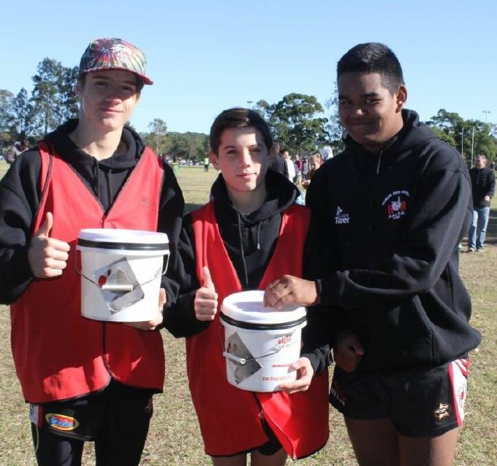 Red Rovers under 14 players Ethan Collings and Christian Petrou collect money from fellow player Drew Mercy.
